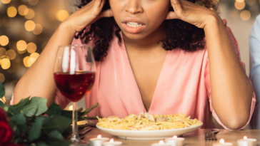 Woman embarrassed by her date's behavior at restaurant
