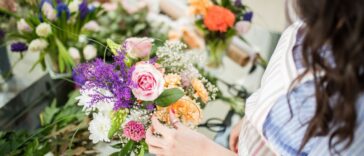 A woman arranges wedding flowers