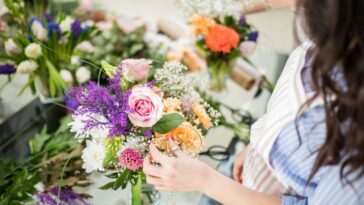 A woman arranges wedding flowers
