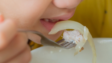 Young child eating an onion
