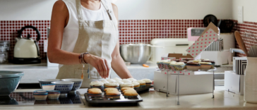 Woman baking variety of goodies for work