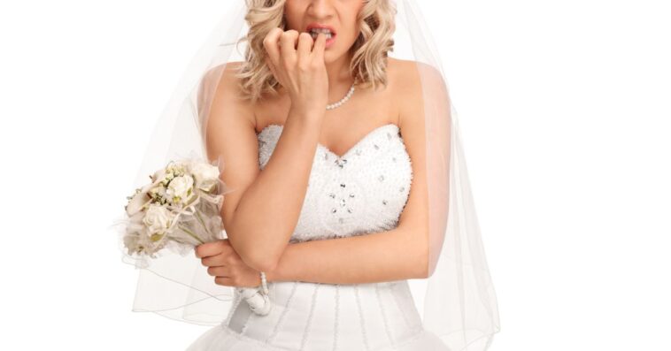 A worried bride chews her nails