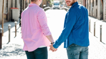 two young gay men holding hands