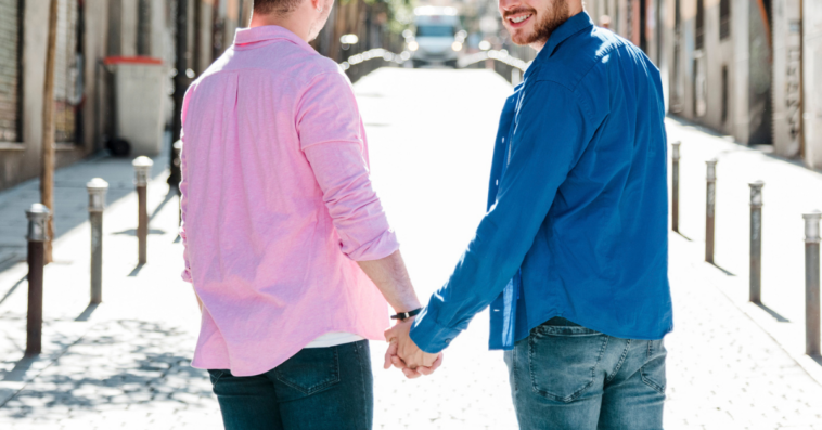 two young gay men holding hands
