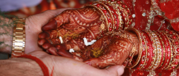 Indian bride holding hands with groom