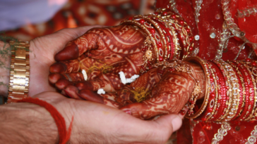 Indian bride holding hands with groom