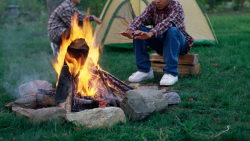 Boy by campfire