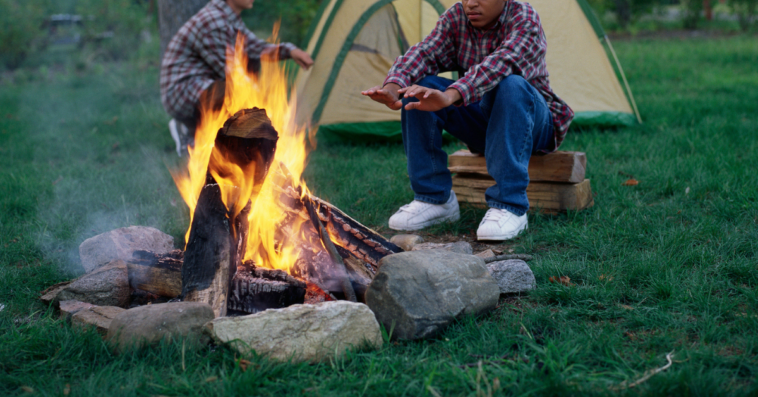 Boy by campfire