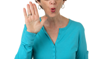 Offended older woman holding up her hand in disagreement