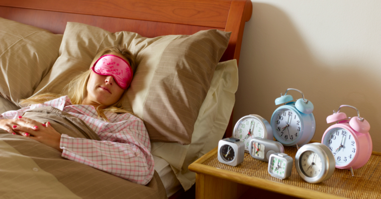 Woman with multiple alarm clocks