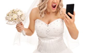 A furious bride looks into a phone while holding a bouquet