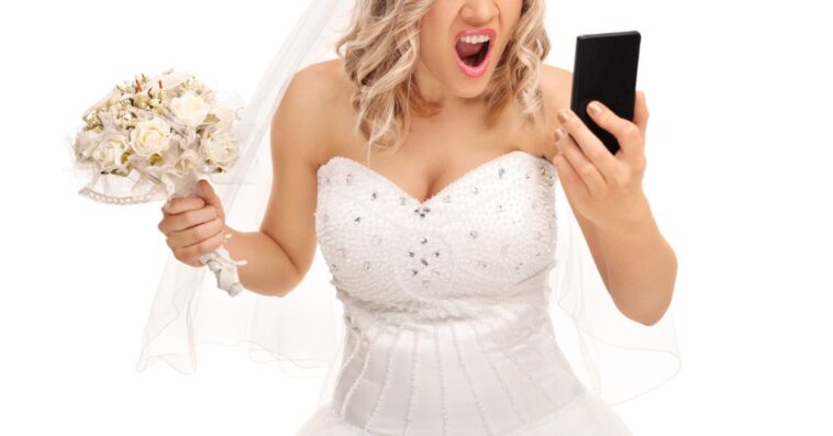 A furious bride looks into a phone while holding a bouquet
