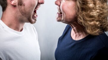 A mother and son are face to face in a heated moment