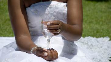 Bride drinking water at her wedding
