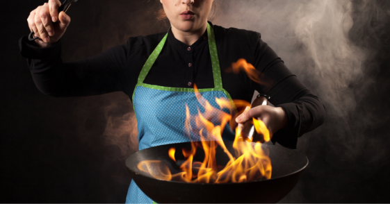 Woman with pan full of fire