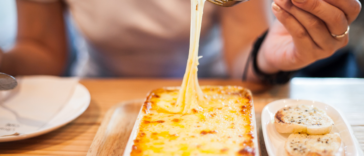 Woman eating lasagna