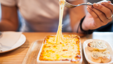 Woman eating lasagna