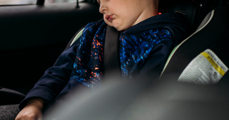 Young child sleeping in car