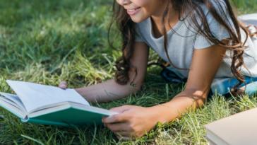 Girl reading a book outside