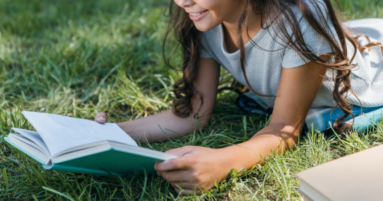Girl reading a book outside