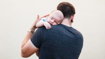A man holds a baby