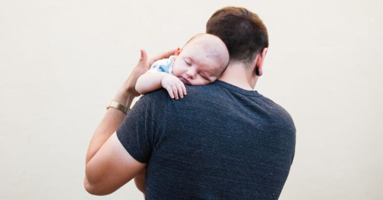 A man holds a baby