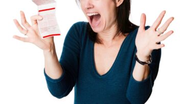 A woman is excited about her lottery ticket