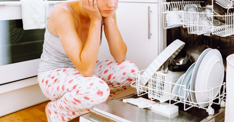 Teenager looking at dishwasher