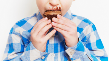 Boy eating chocolate cupcakes