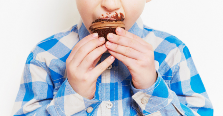 Boy eating chocolate cupcakes
