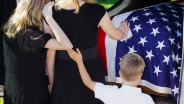 Widowed woman at funeral with her children
