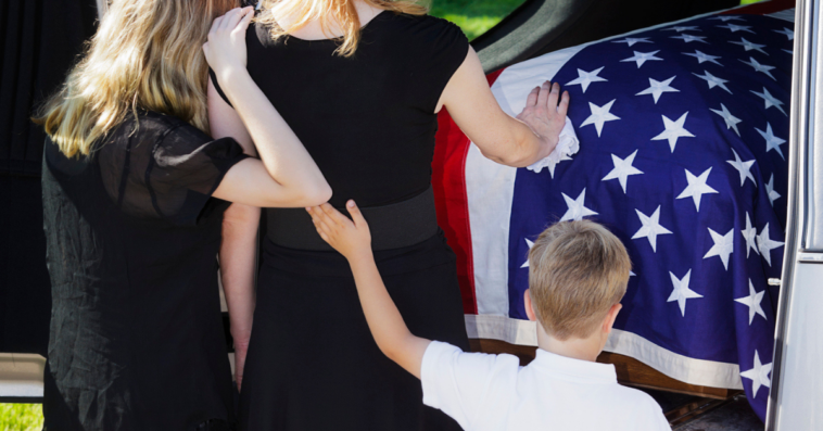 Widowed woman at funeral with her children