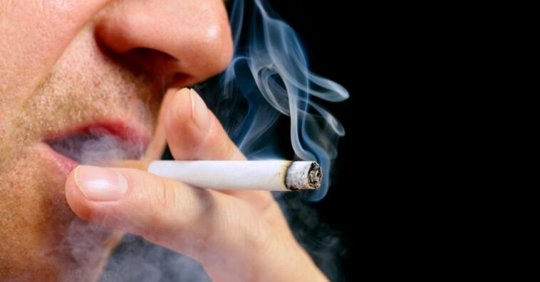 Close up of a man's mouth with with a cigarette