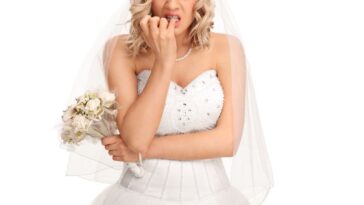 An upset bride gnaws at her pinky finger