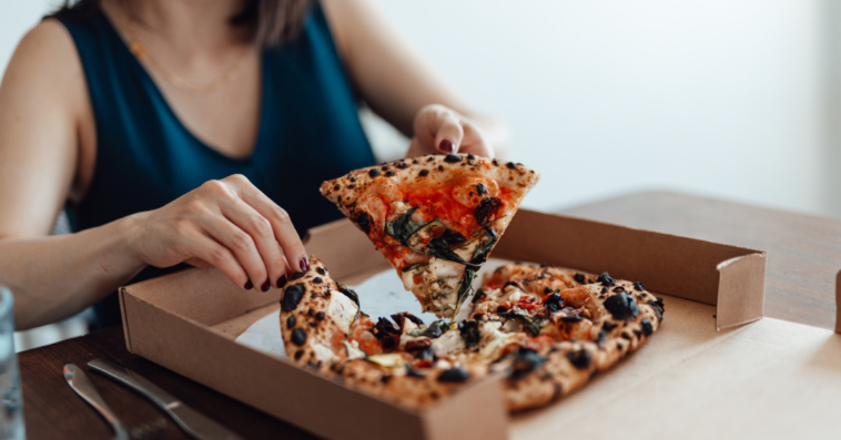 woman eating pizza