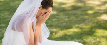 Bride crying into her hands