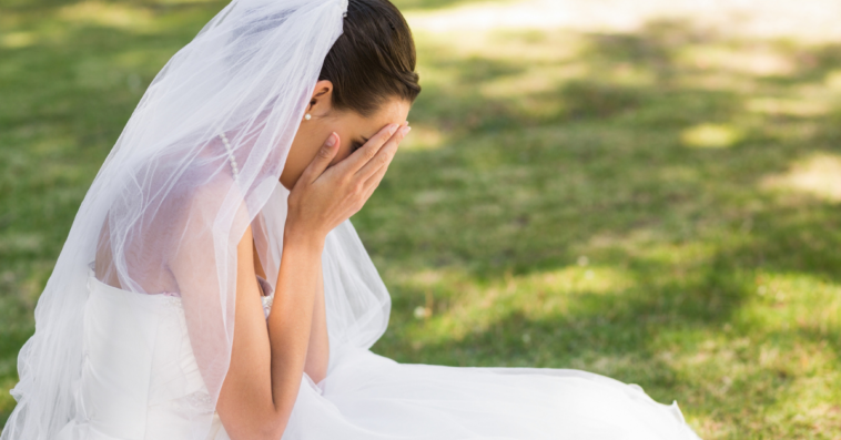 Bride crying into her hands