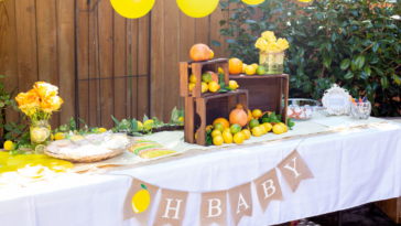 Table at baby shower with “oh baby” banner