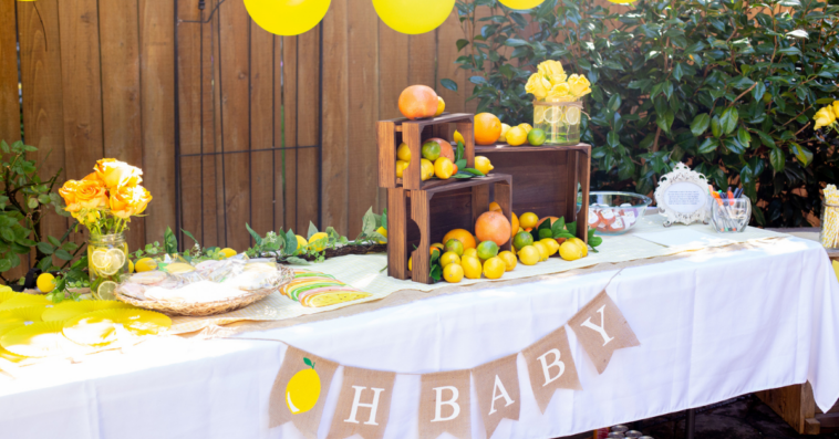 Table at baby shower with “oh baby” banner