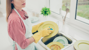 Angry woman washing dishes