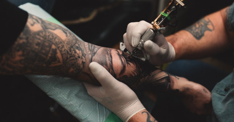 Man getting a tattoo on his arm.