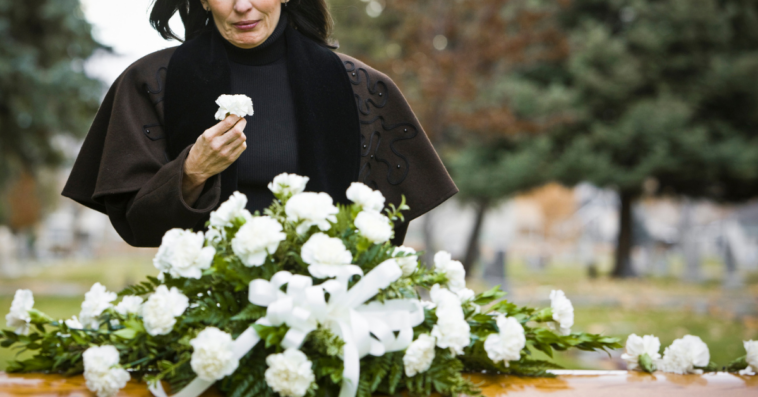 A woman grieving at grave