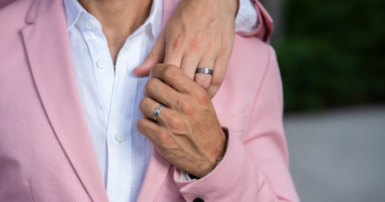 Gay couple wearing wedding rings