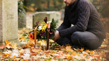 Grieving father at child's gravesite