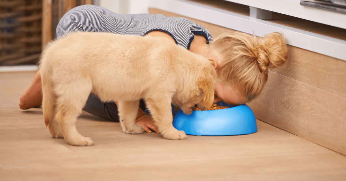 aunt-feeds-her-teething-niece-a-dog-treat-for-a-snack