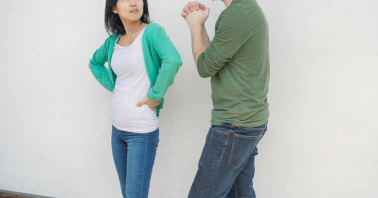 Frustrated woman looking at man pleading