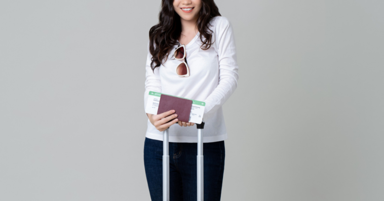 Young woman with passport and suitcase