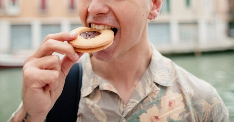 A guy eats a cookie