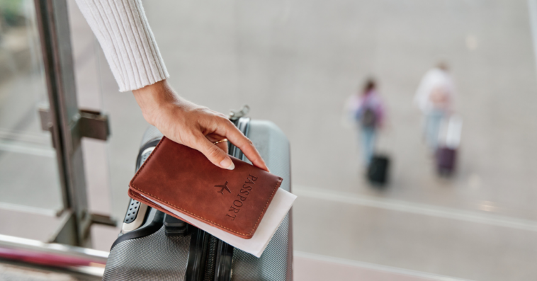 Woman holding passport and suitcase