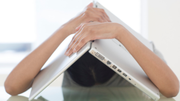 Woman with laptop over her head
